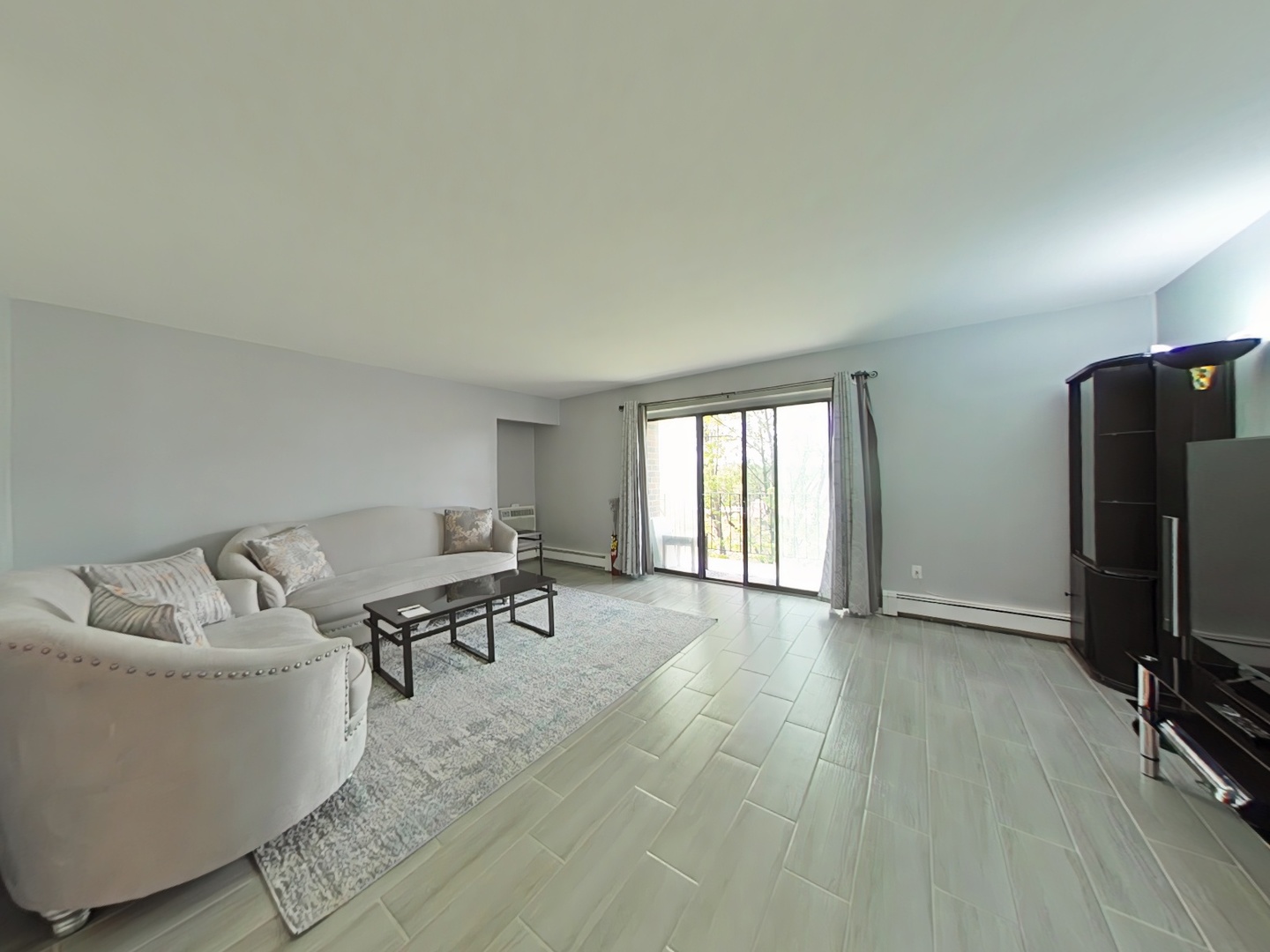 4721 St Joseph Creek Road, Unit 5F Lisle, IL 60532 - Photo 4 of 19 a living room with furniture and a flat screen tv