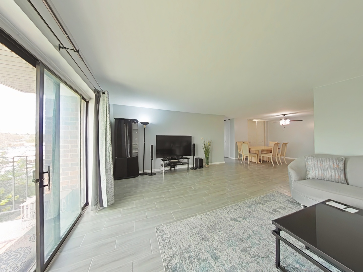 4721 St Joseph Creek Road, Unit 5F Lisle, IL 60532 - Photo 5 of 19 a living room with furniture and a flat screen tv