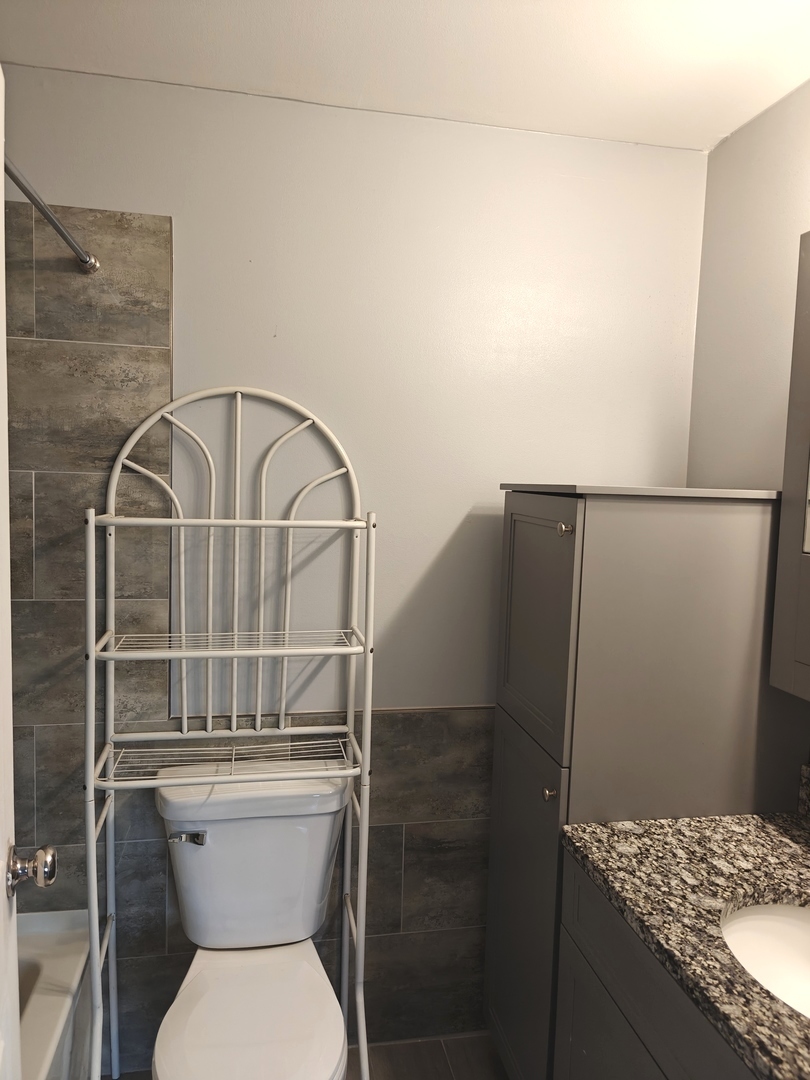 4721 St Joseph Creek Road, Unit 5F Lisle, IL 60532 - Photo 8 of 19 a bathroom with a toilet and a sink