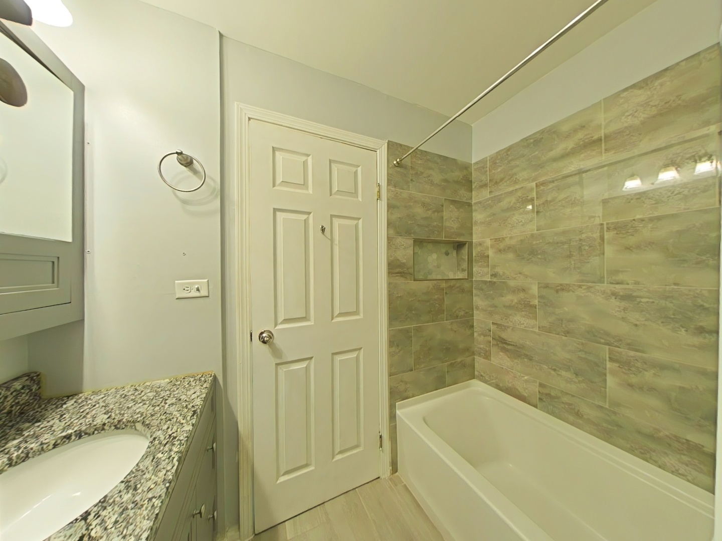 4721 St Joseph Creek Road, Unit 5F Lisle, IL 60532 - Photo 9 of 19 a bathroom with a granite countertop sink a mirror bathtub and shower