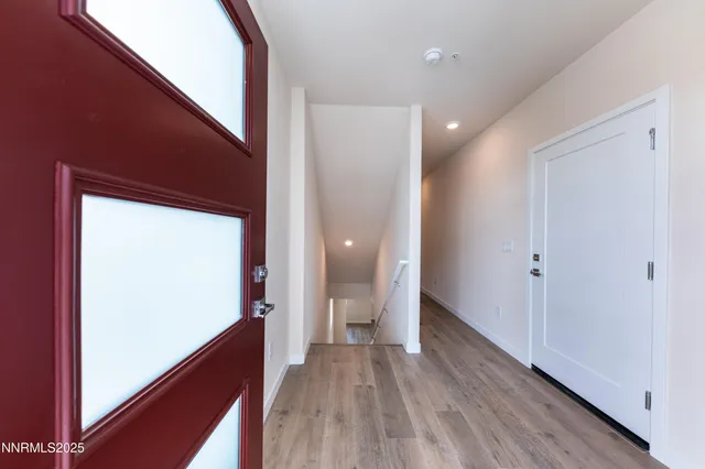a view of hallway with wooden floor