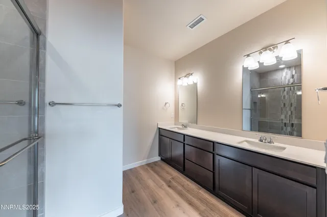 a bathroom with a double vanity sink and mirror