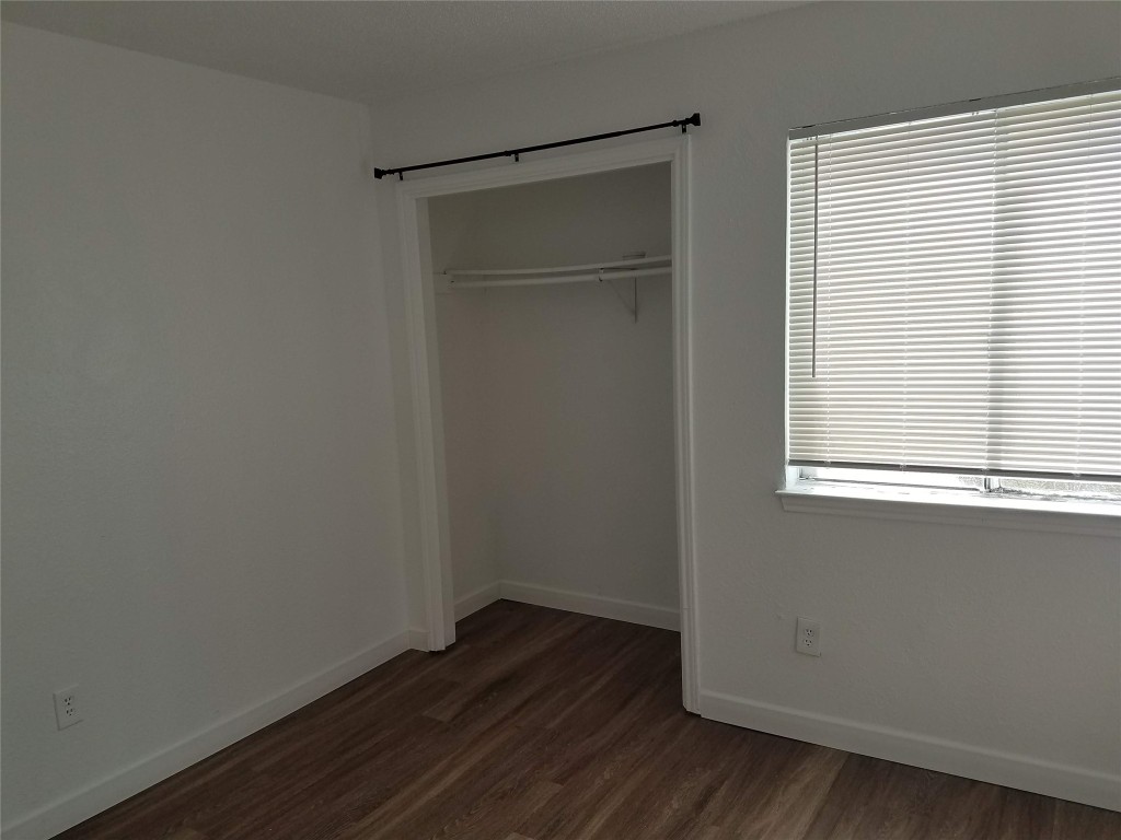 8503 Colony Loop Drive Austin, TX 78724 - Photo 3 of 4 a view of an empty room with wooden floor and a window