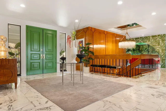 a bedroom with a large bed and a large window