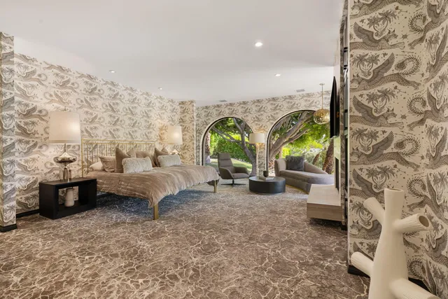 a living room with furniture and a large window with garden view