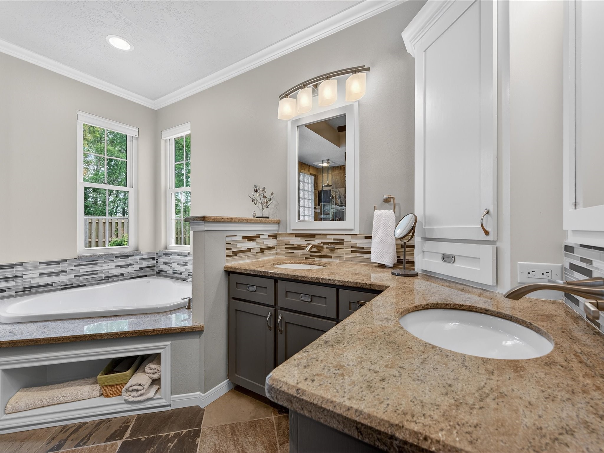 6207 Sandypine Drive Spring, TX 77379 - Photo 23 of 46 Featuring granite countertops, dual sinks, soaking tub, walk-in shower, and custom built-ins that combine beauty with everyday functionality.