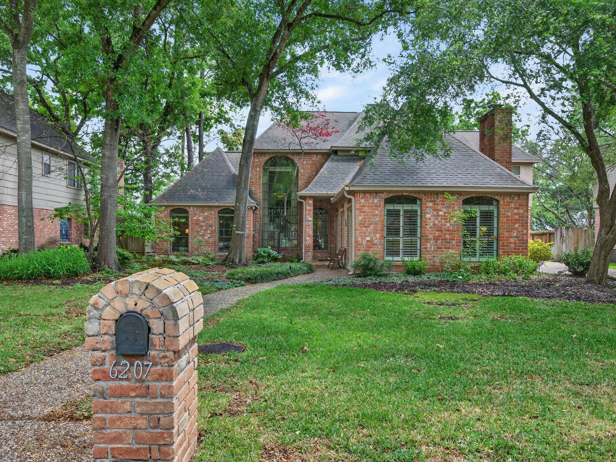 6207 Sandypine Drive Spring, TX 77379 - Photo 6 of 46 From the moment you arrive, the timeless brick façade, mature trees, and fresh exterior paint (2026) create a warm, inviting presence that instantly feels like home.