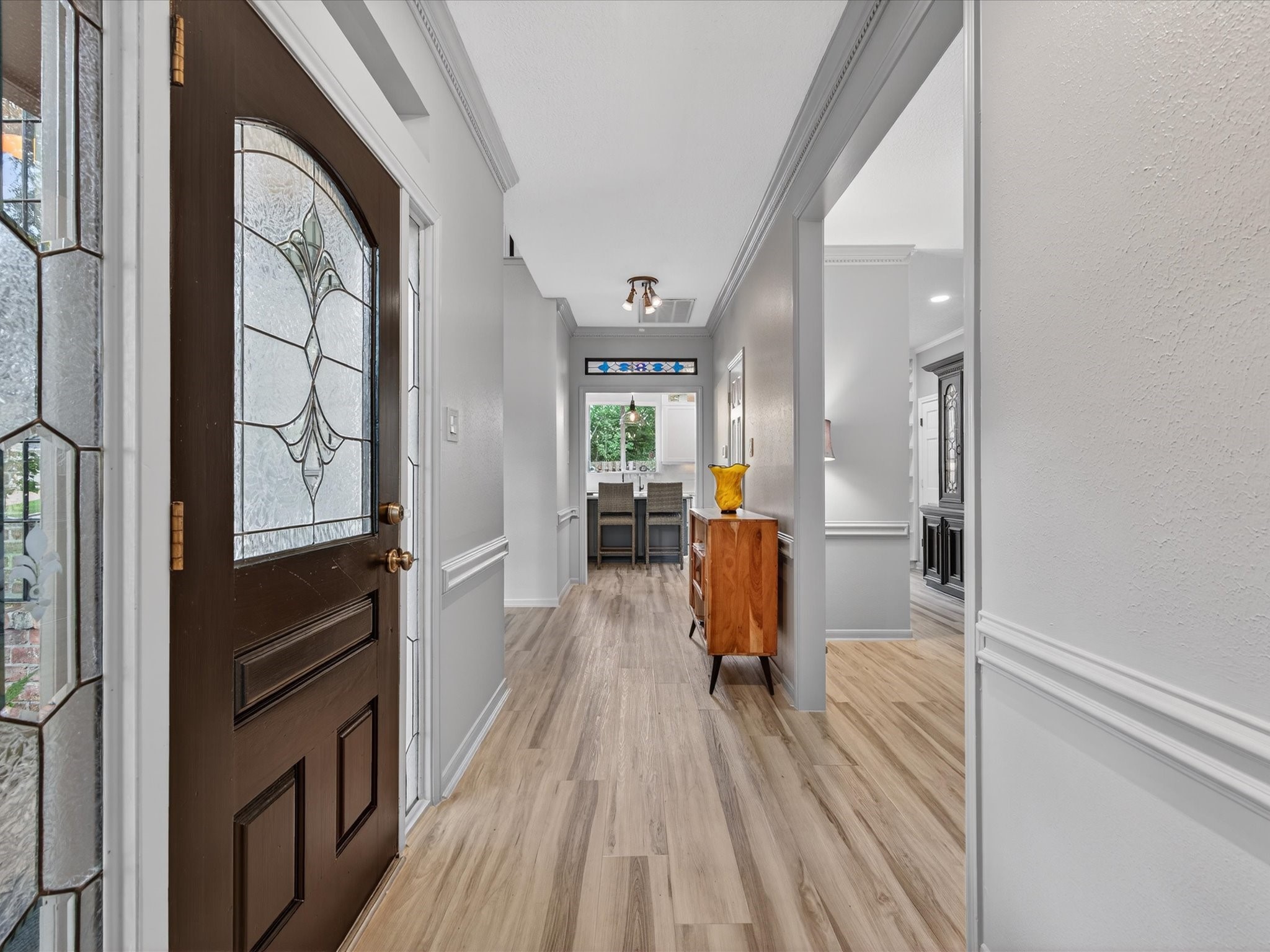 6207 Sandypine Drive Spring, TX 77379 - Photo 8 of 46 Step inside to a light-filled entry enhanced by fresh interior paint (2025) and durable luxury vinyl plank flooring, setting a polished, updated tone from the start.