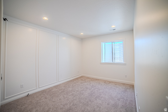 45 North Scarlet Maple Road, Unit 4317 Vineyard, UT 84059 - Photo 35 of 35 Recessed lighting illuminating a spacious room with light-colored carpeting