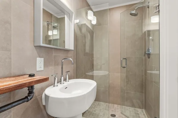 a bathroom with a sink a toilet and shower