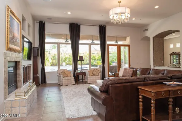 a living room with furniture and a chandelier