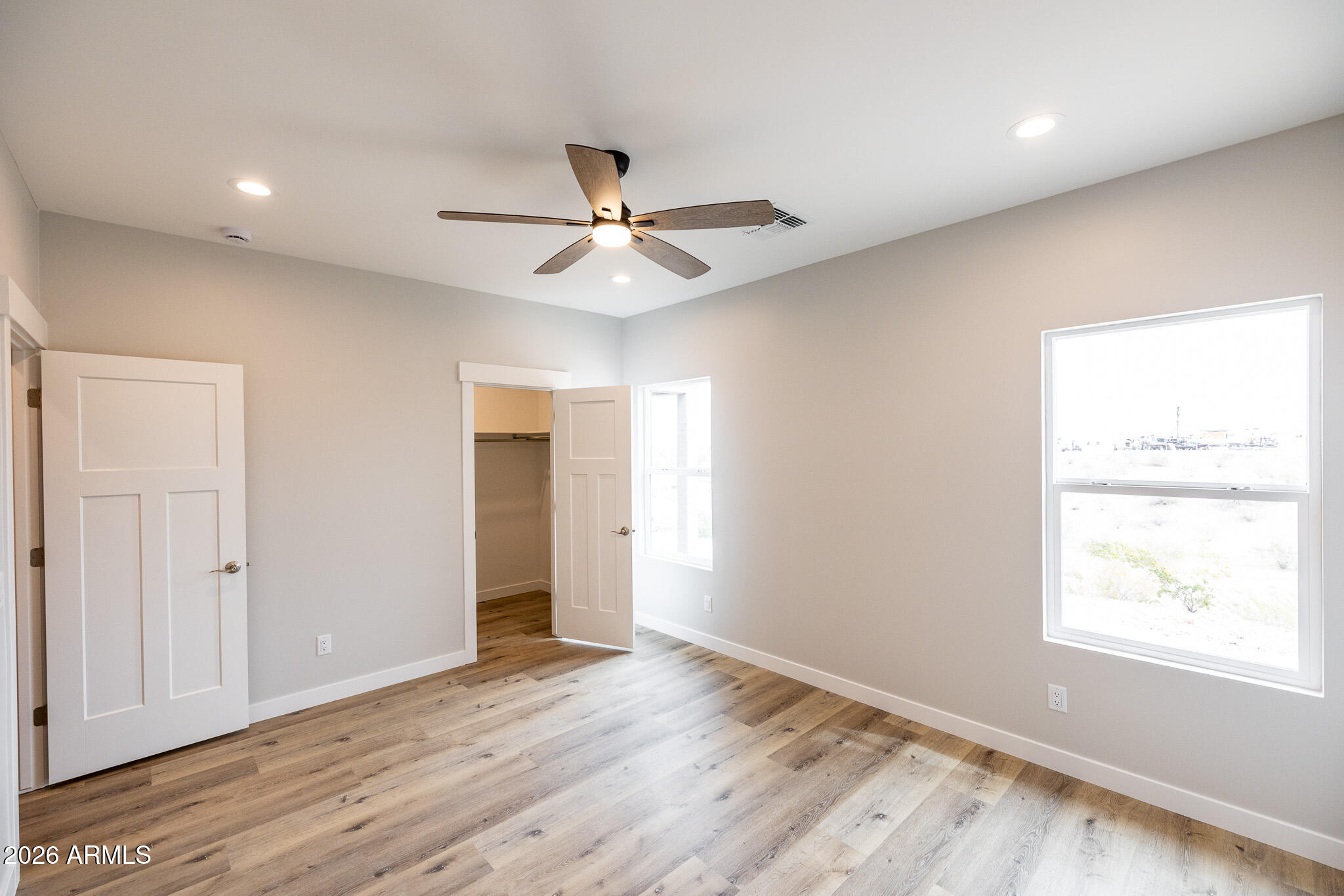 11459 East Adamsville Road Florence, AZ 85132 - Photo 29 of 63 a view of an empty room with wooden floor and a window