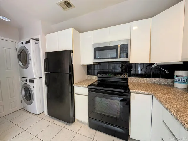a kitchen with a refrigerator and a sink