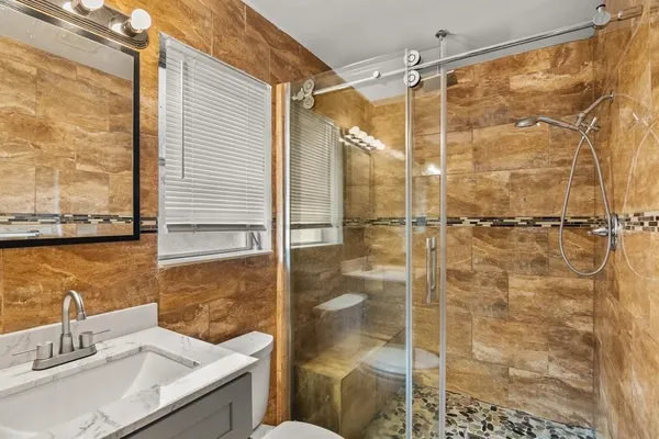 a bathroom with a shower and a sink