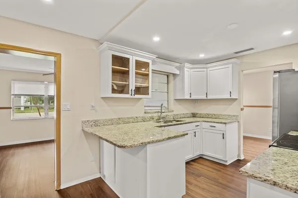 a kitchen with a sink stove and cabinets