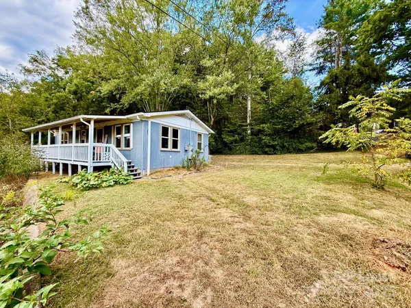 a front view of a house with a garden and yard