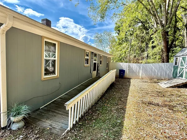 a view of a house with a large tree