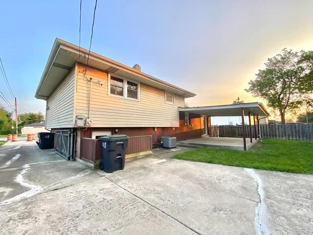 a view of a house with a yard and a garden