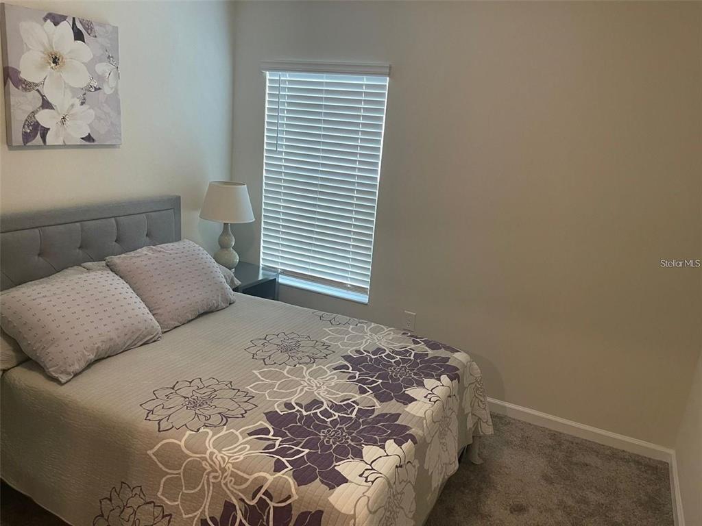 4491 Magnolia Ridge Court Kissimmee, FL 34746 - Photo 11 of 21 a bedroom with a bed and a window