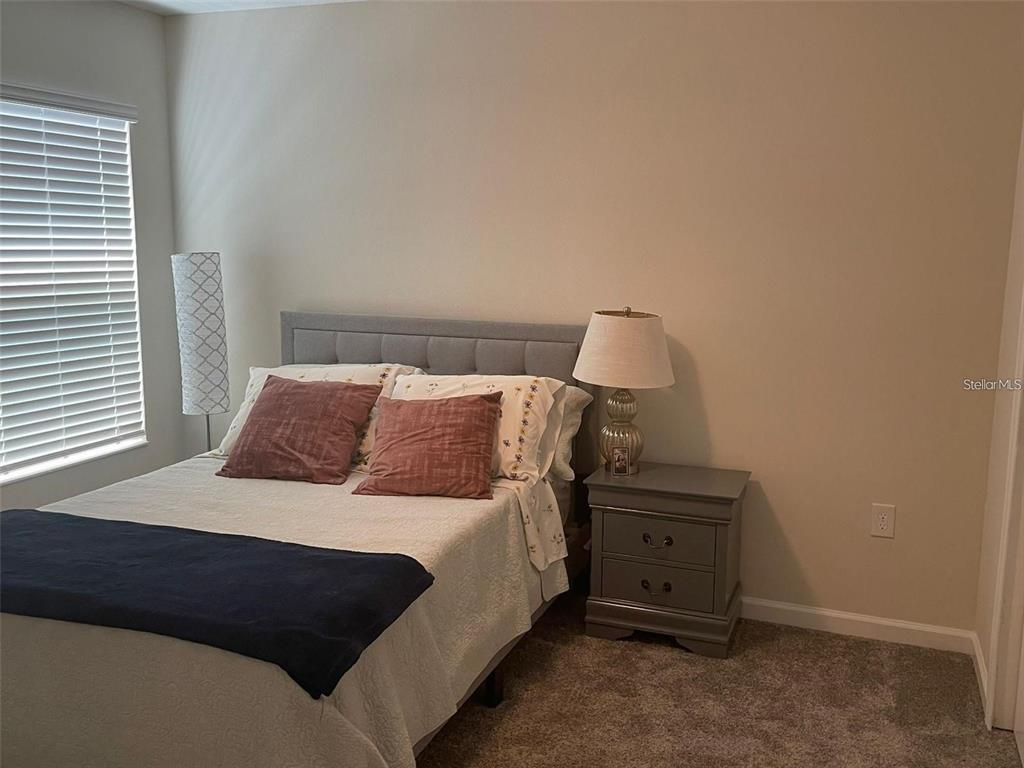 4491 Magnolia Ridge Court Kissimmee, FL 34746 - Photo 12 of 21 a bedroom with a bed and a window