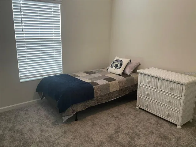 a bedroom with a bed and a dresser