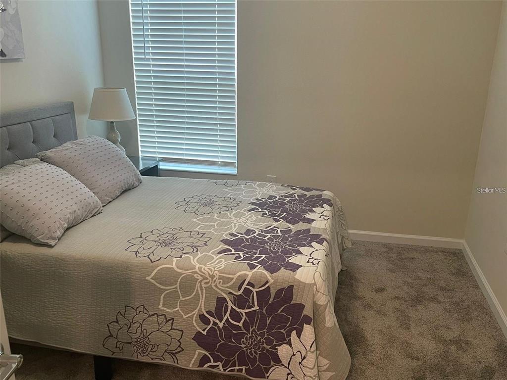 4491 Magnolia Ridge Court Kissimmee, FL 34746 - Photo 15 of 21 a bedroom with a bed and a window