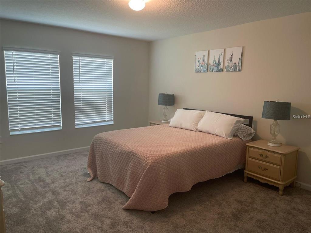 4491 Magnolia Ridge Court Kissimmee, FL 34746 - Photo 17 of 21 a bedroom with a bed and a window