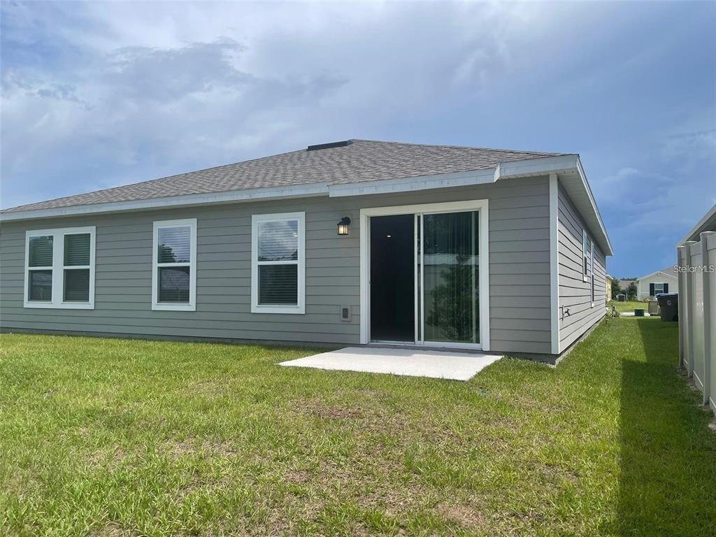 4491 Magnolia Ridge Court Kissimmee, FL 34746 - Photo 20 of 21 a view of a backyard with plants and large tree