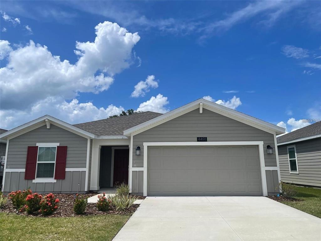 4491 Magnolia Ridge Court Kissimmee, FL 34746 - Photo 2 of 21 a front view of a house with a yard