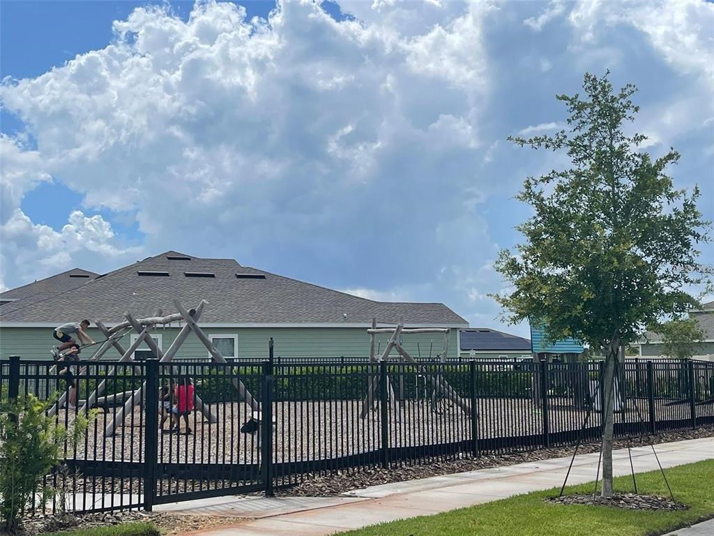 4491 Magnolia Ridge Court Kissimmee, FL 34746 - Photo 21 of 21 a view of a white house with a small yard and a garden