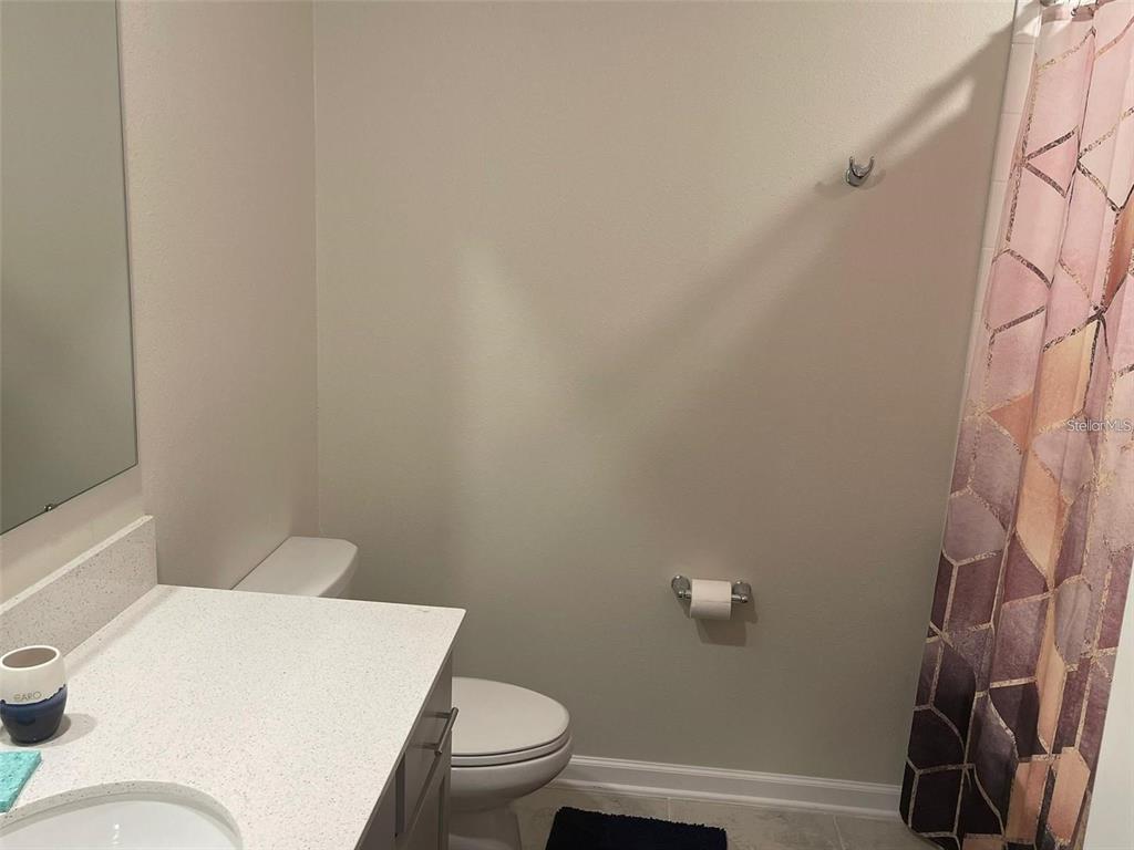 4491 Magnolia Ridge Court Kissimmee, FL 34746 - Photo 4 of 21 a white toilet sitting next to a bath tub