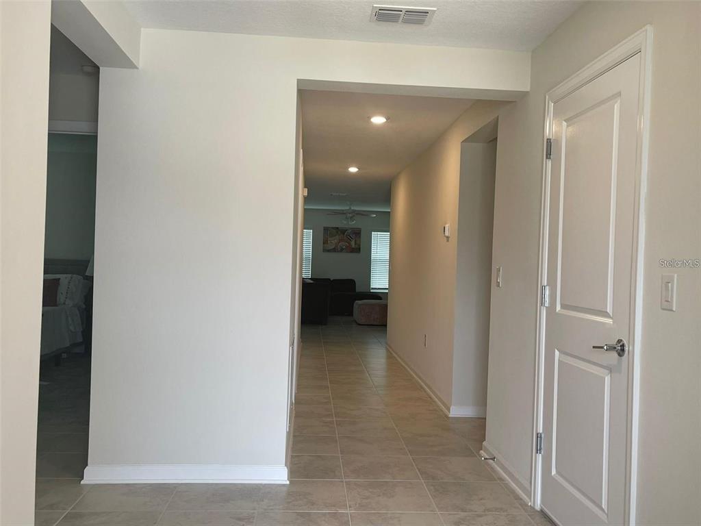 4491 Magnolia Ridge Court Kissimmee, FL 34746 - Photo 6 of 21 a view of a hallway with wooden shelves