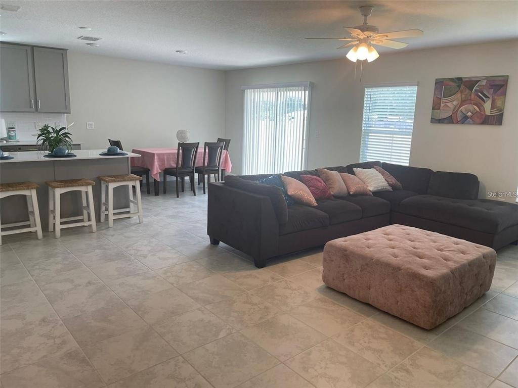 4491 Magnolia Ridge Court Kissimmee, FL 34746 - Photo 7 of 21 a living room with furniture and a large window