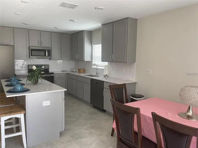 a kitchen that has a sink and a stove in it