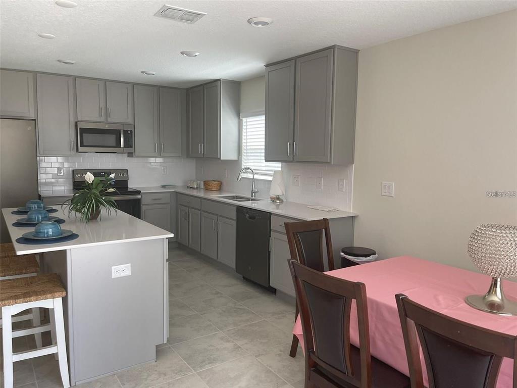4491 Magnolia Ridge Court Kissimmee, FL 34746 - Photo 10 of 21 a kitchen that has a sink and a stove in it