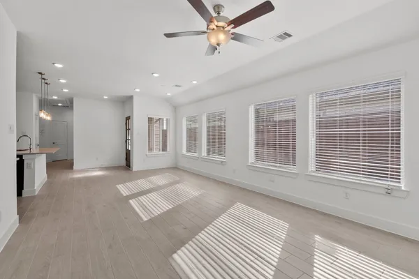 a kitchen with kitchen island stainless steel appliances a sink and a refrigerator