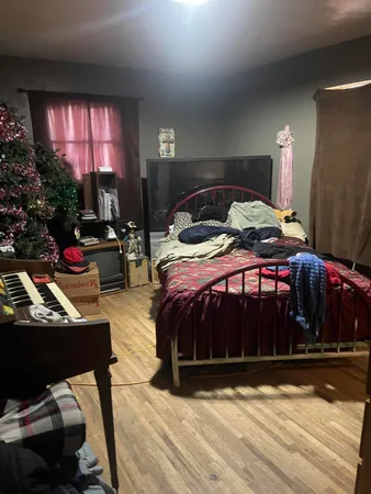 a bedroom with a bed window and a table