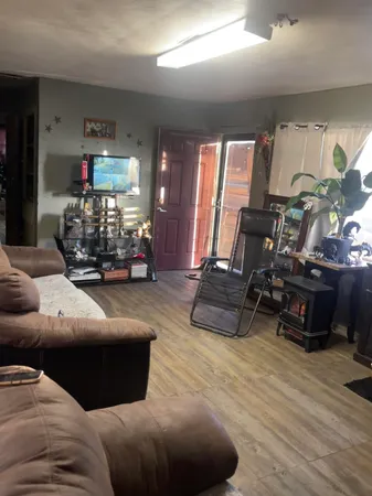 a living room with furniture gym equipment and a large window