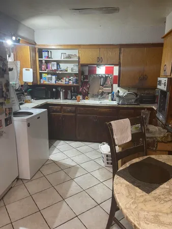 a kitchen with a sink cabinets and window