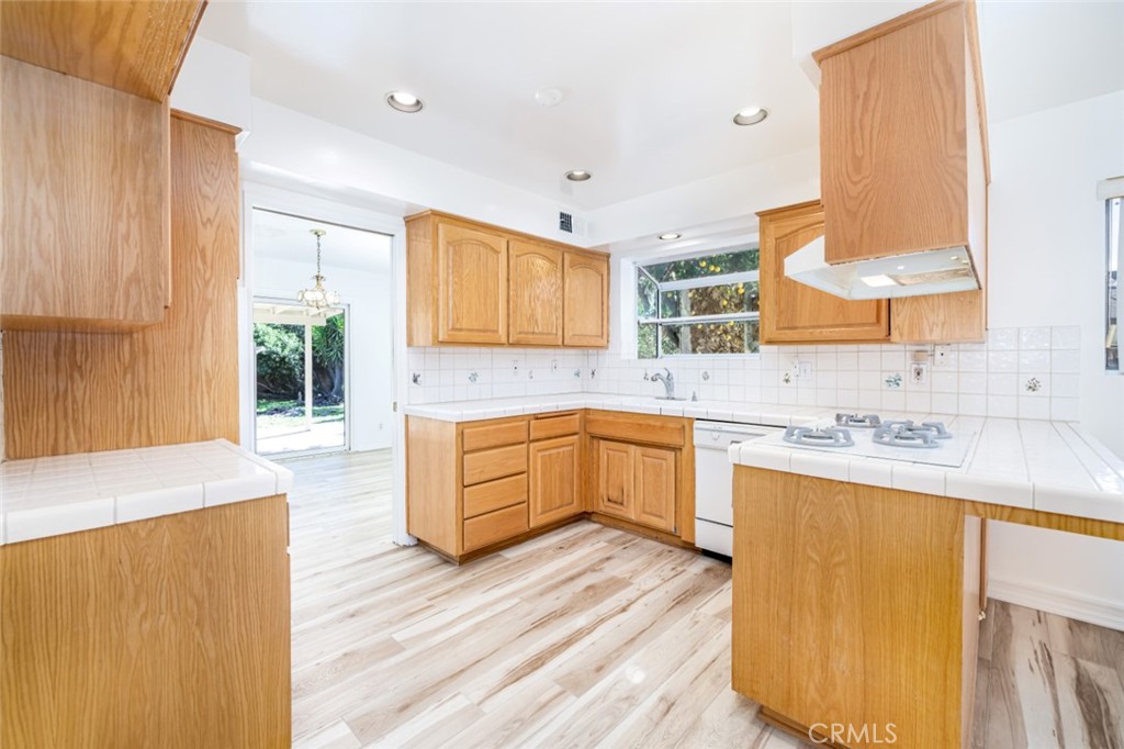15838 Eccles Street North Hills, CA 91343 - Photo 11 of 38 a large kitchen with a sink and a stove top oven