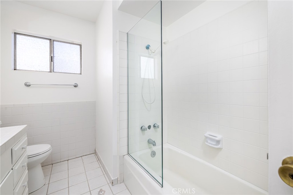 15838 Eccles Street North Hills, CA 91343 - Photo 19 of 38 a bathroom with a granite countertop bathtub shower and toilet