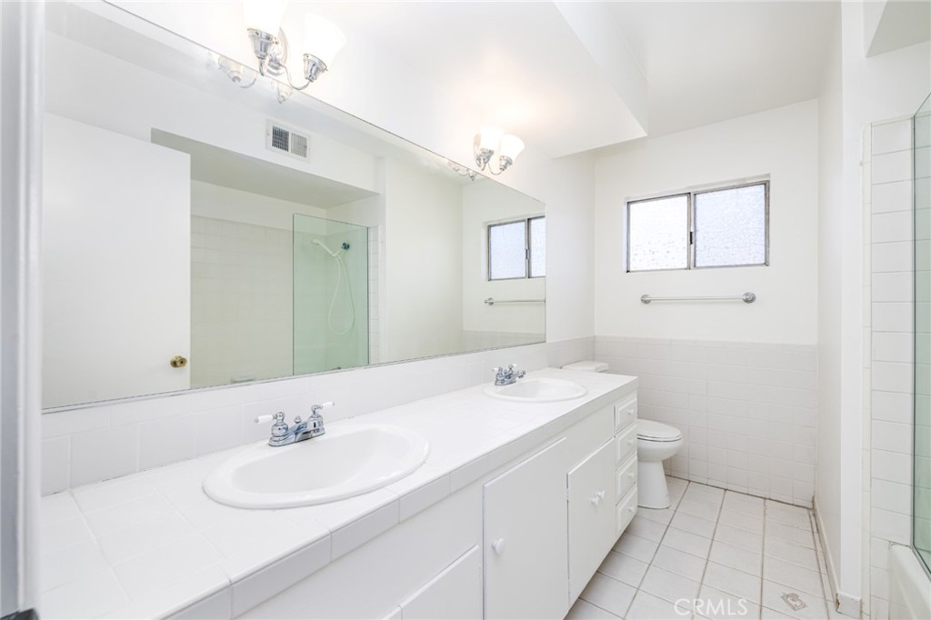 15838 Eccles Street North Hills, CA 91343 - Photo 20 of 38 a bathroom with a double vanity sink mirror and