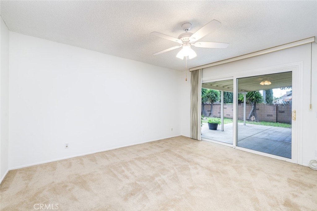 15838 Eccles Street North Hills, CA 91343 - Photo 28 of 38 an empty room with floor to ceiling windows and ceiling fan