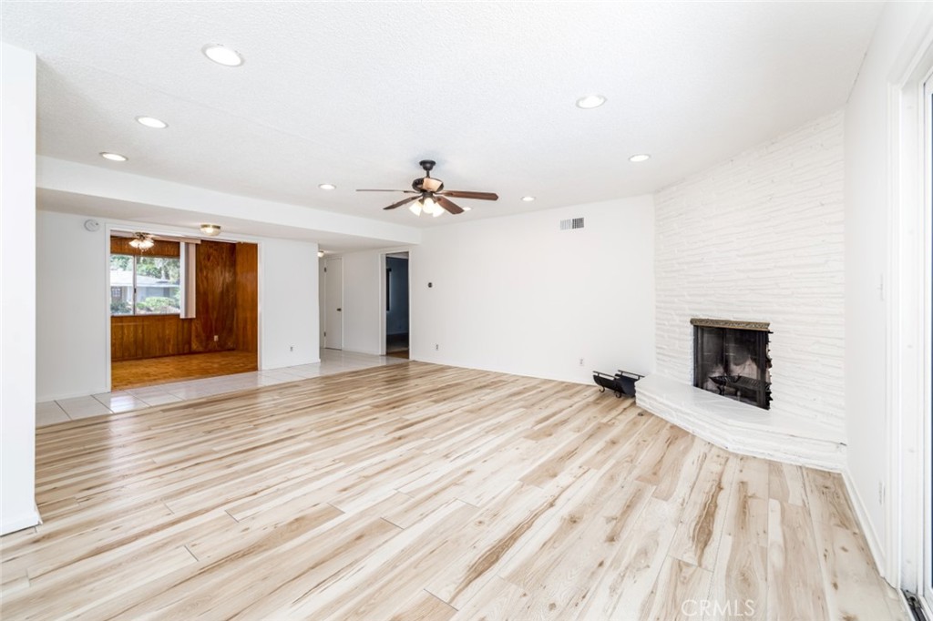 15838 Eccles Street North Hills, CA 91343 - Photo 4 of 38 a view of an empty room with wooden floor and a fireplace