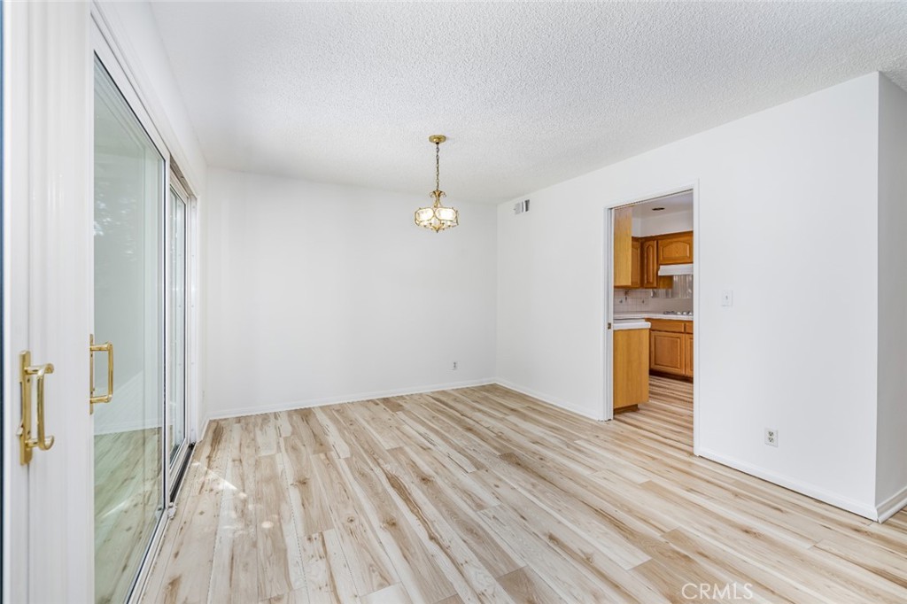 15838 Eccles Street North Hills, CA 91343 - Photo 7 of 38 a view of empty room with wooden floor and windows