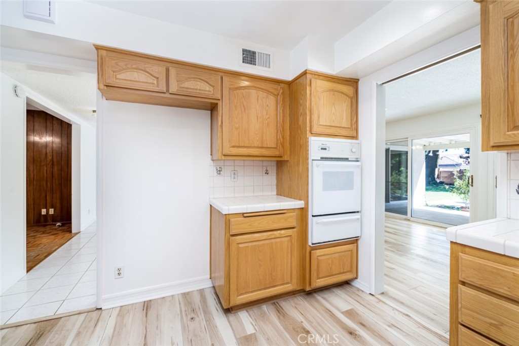 15838 Eccles Street North Hills, CA 91343 - Photo 8 of 38 a kitchen with stainless steel appliances granite countertop a refrigerator and a stove top oven
