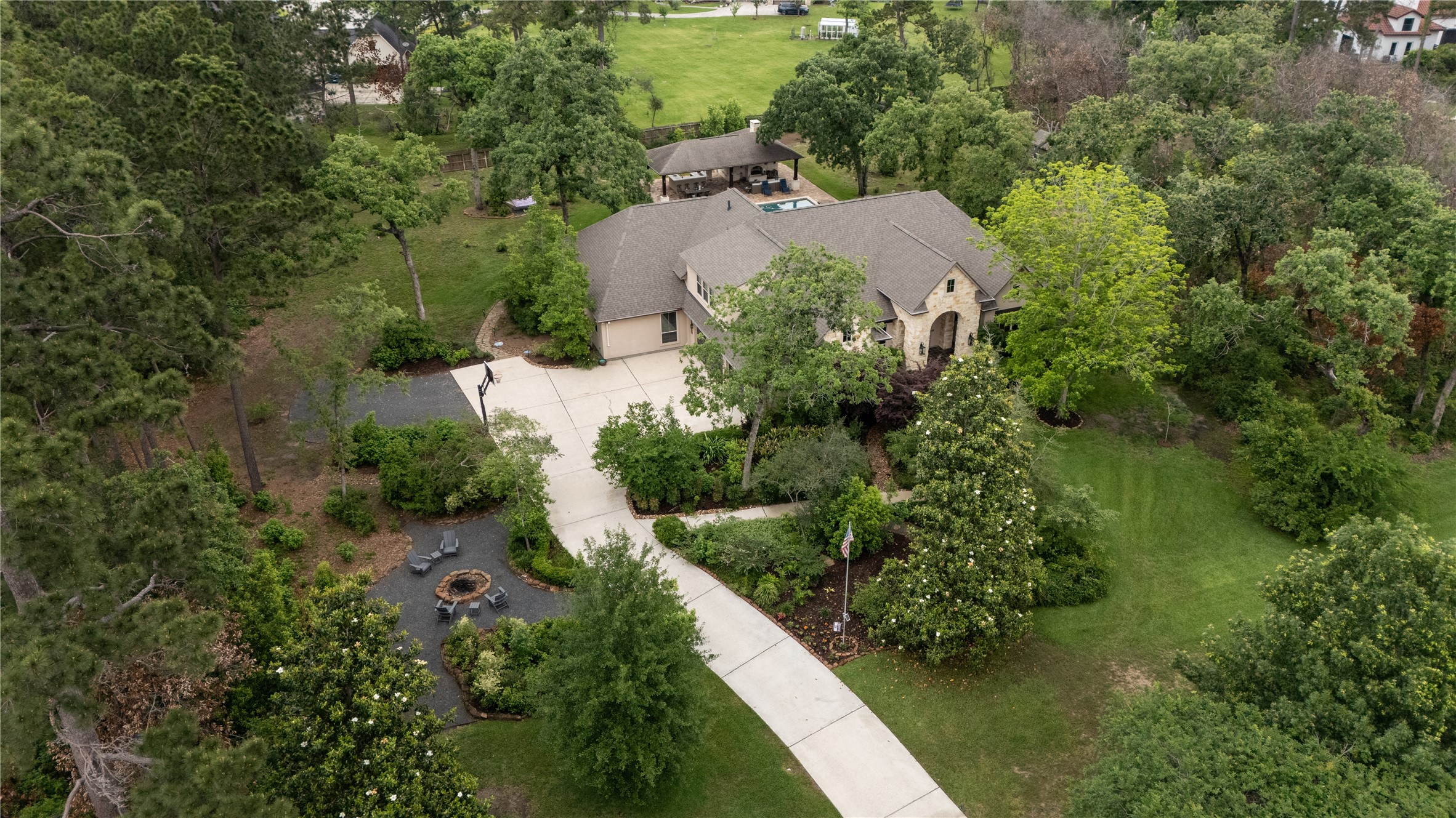 an aerial view of a house with a yard and lake view