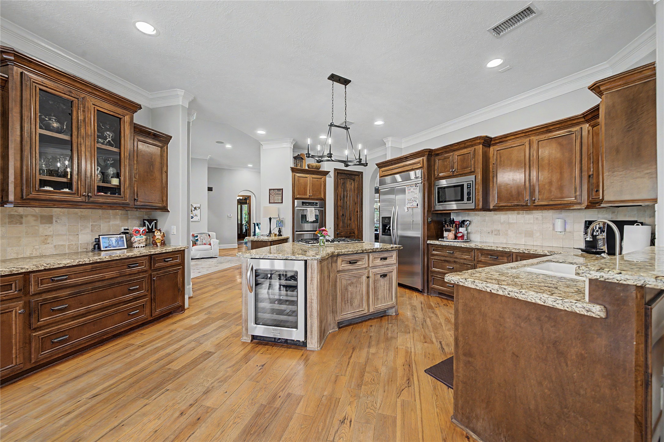 4423 Silver Jade Drive Spring, TX 77386 - Photo 11 of 45 a large kitchen with stainless steel appliances granite countertop a stove a sink dishwasher and a oven with cabinets