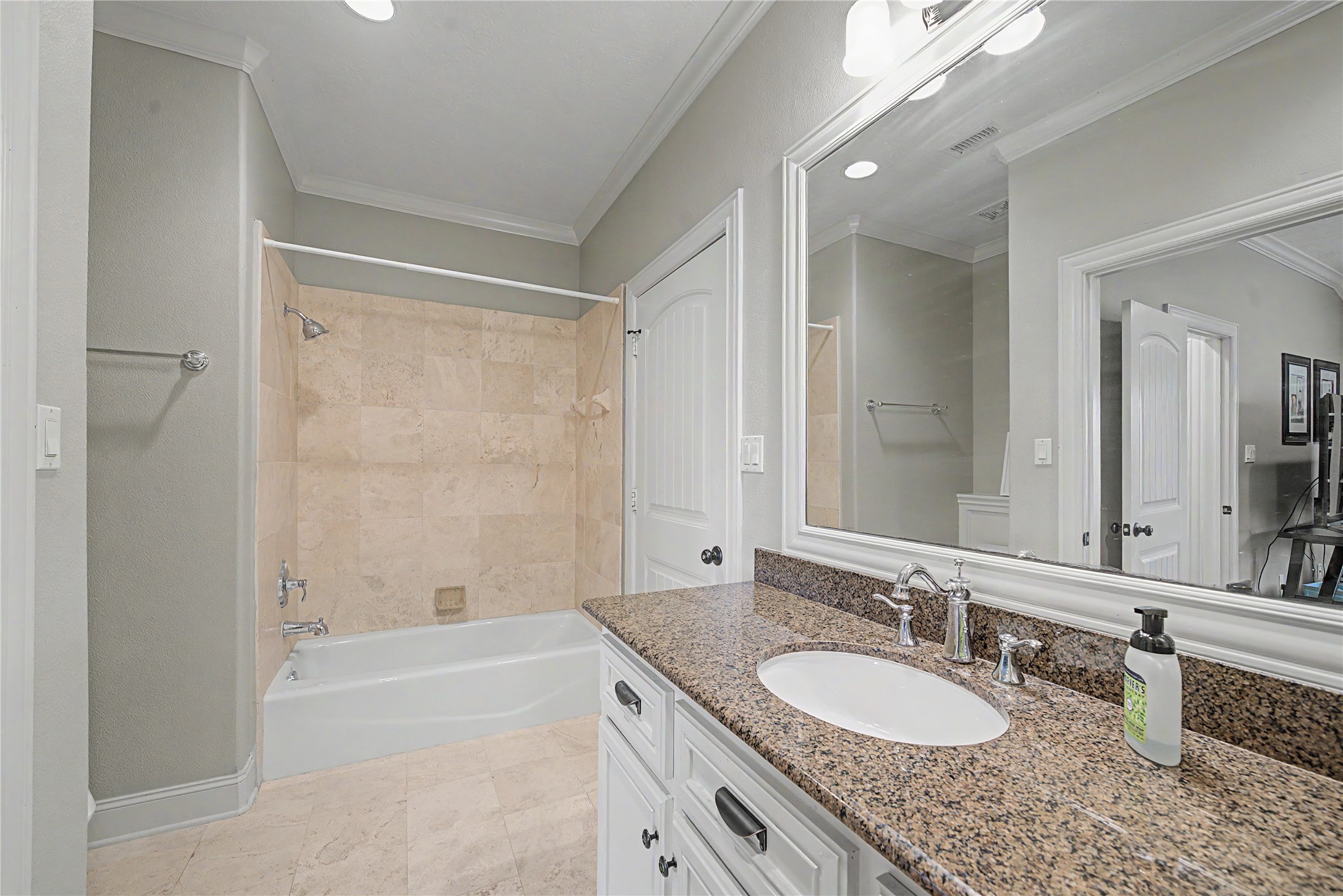 4423 Silver Jade Drive Spring, TX 77386 - Photo 26 of 45 a bathroom with a granite countertop sink double mirror and a bathtub