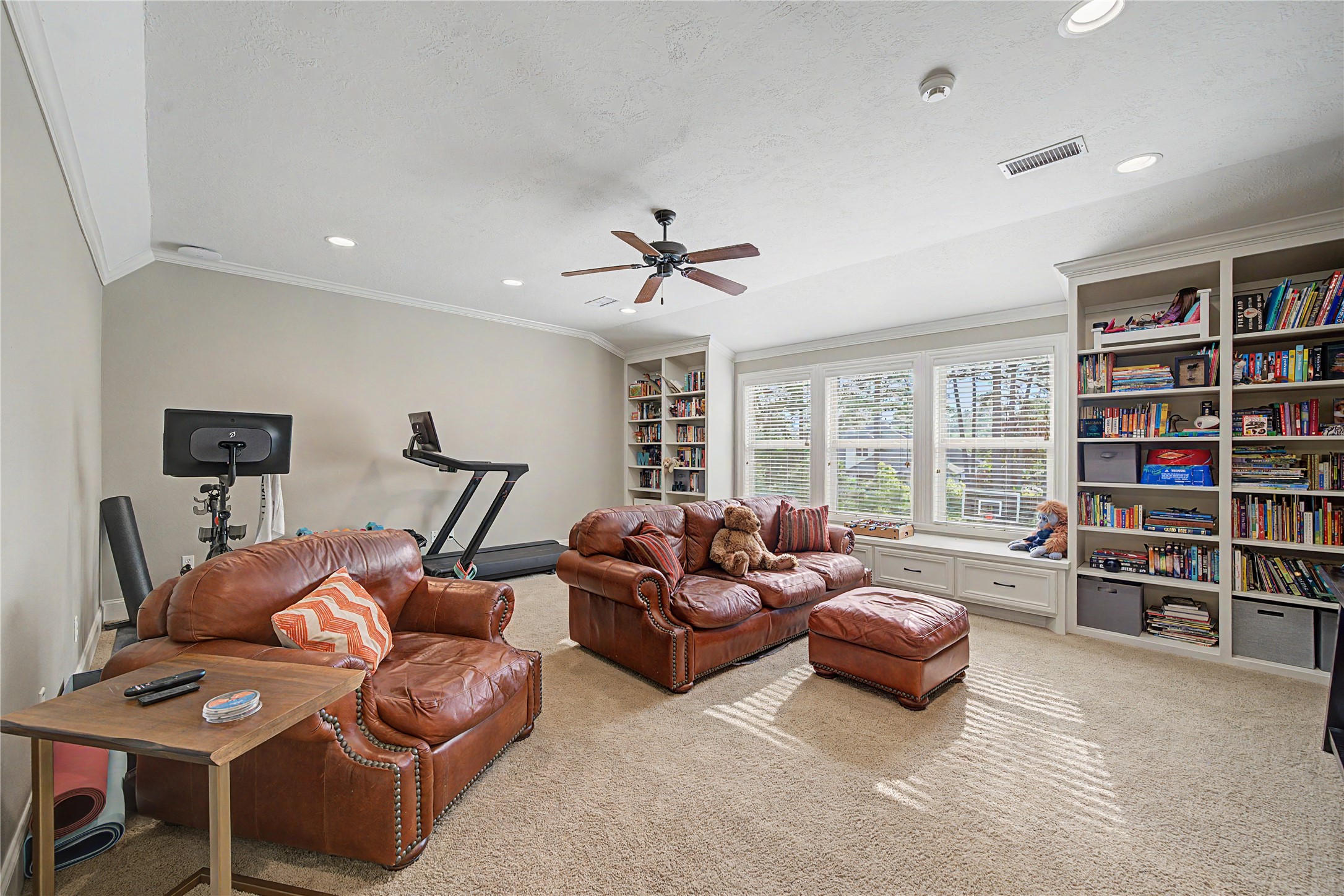 4423 Silver Jade Drive Spring, TX 77386 - Photo 27 of 45 a living room with furniture and a book shelf